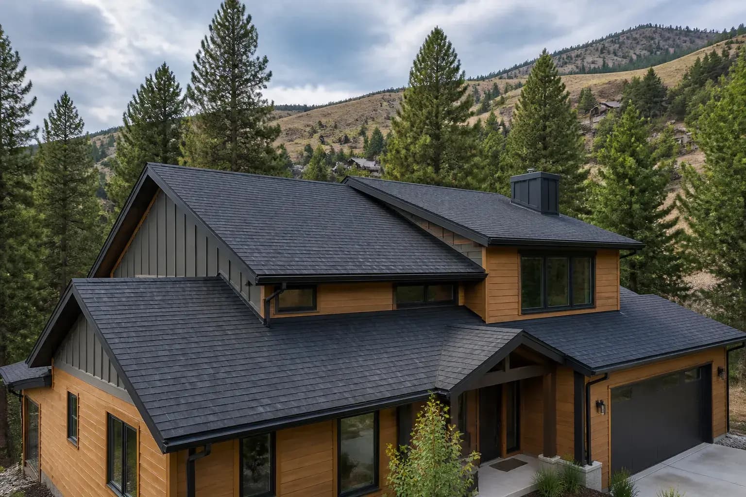 Fresh roof replacement on a Missoula home with pine trees in the background.