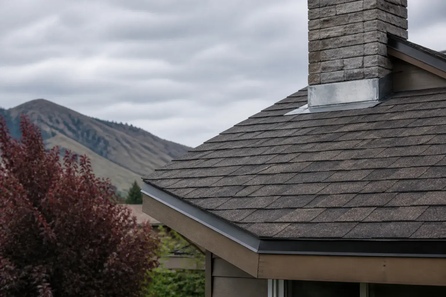 Repaired shingles and flashing on a residential roof.